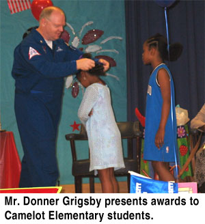 Mr. Donner Grigsby presents awards to Camelot Elementary students